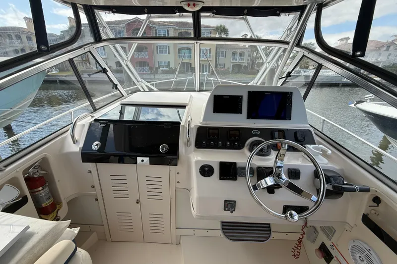 Slide: The Image of 2009 Grady-White Marlin 300 boat helm with steering wheel and navigation equipment. - 10