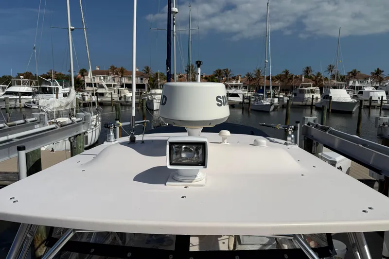 Slide: The Image of 2009 Grady-White Marlin 300 boat docked at marina with radar equipment. - 18