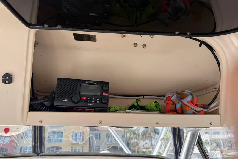 Slide: The Image of 2009 Grady-White Marlin 300 boat interior with Simrad radio and colorful gear storage. - 21