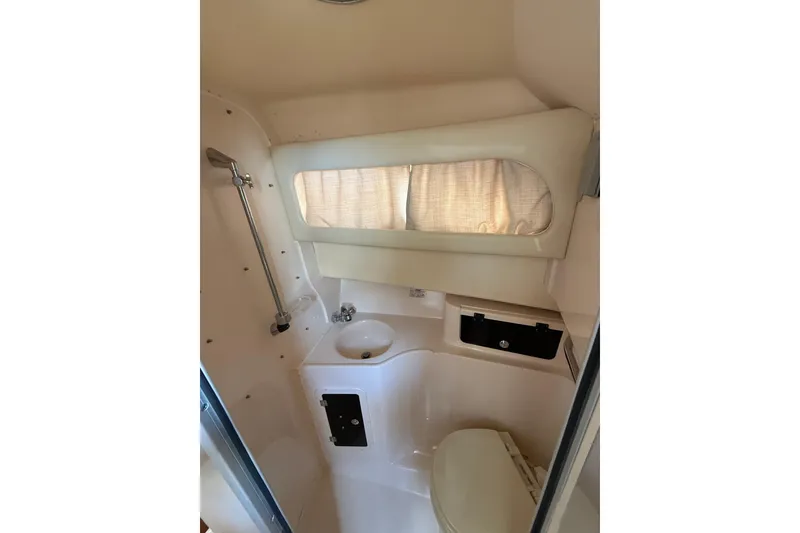 Slide: The Image of 2009 Grady-White Marlin 300 boat bathroom with shower, sink, and toilet. - 23
