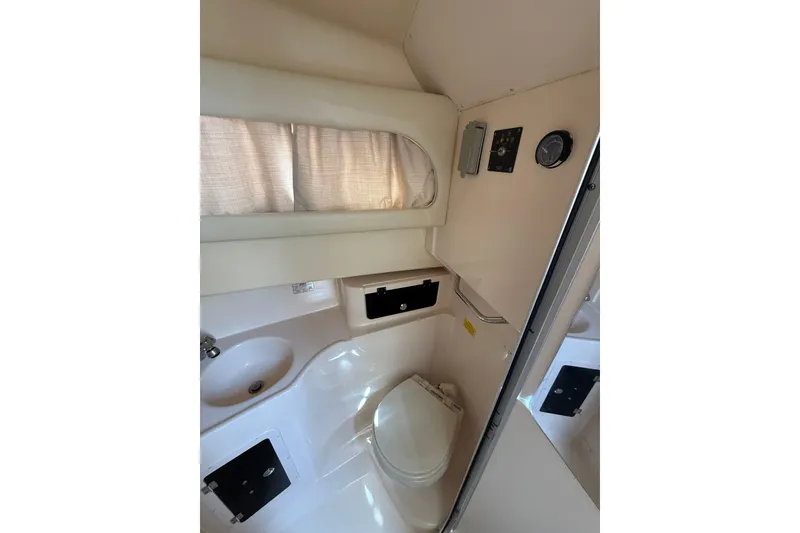Slide: The Image of 2009 Grady-White Marlin 300 boat bathroom interior with sink and toilet. - 24