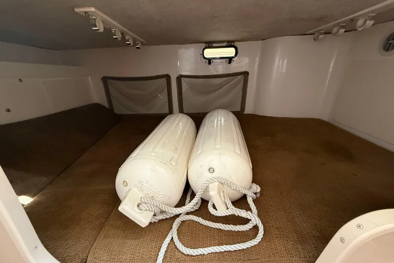 Slide: The Image of 2009 Grady-White Marlin 300 cabin interior with fenders and storage nets. - 25