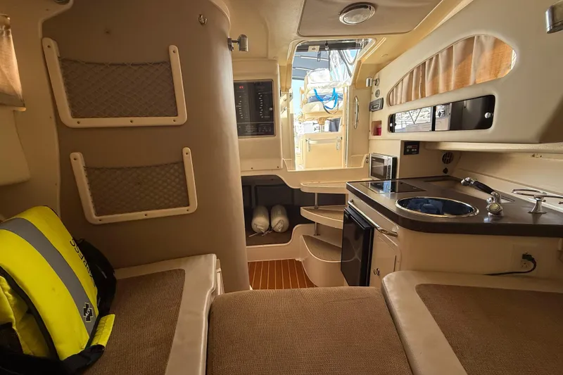 Slide: The Image of Interior of 2009 Grady-White Marlin 300 boat with kitchenette and seating area. - 26