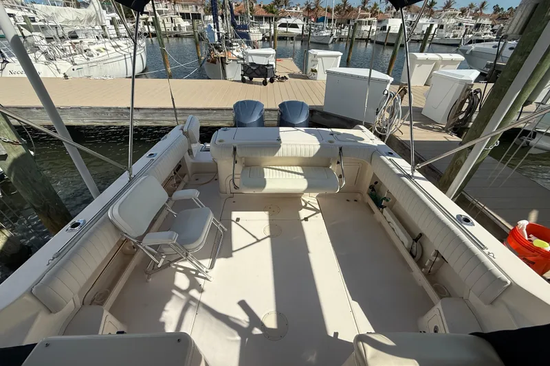 Slide: The Image of 2009 Grady-White Marlin 300 boat interior at marina, featuring spacious seating and dock view. - 27