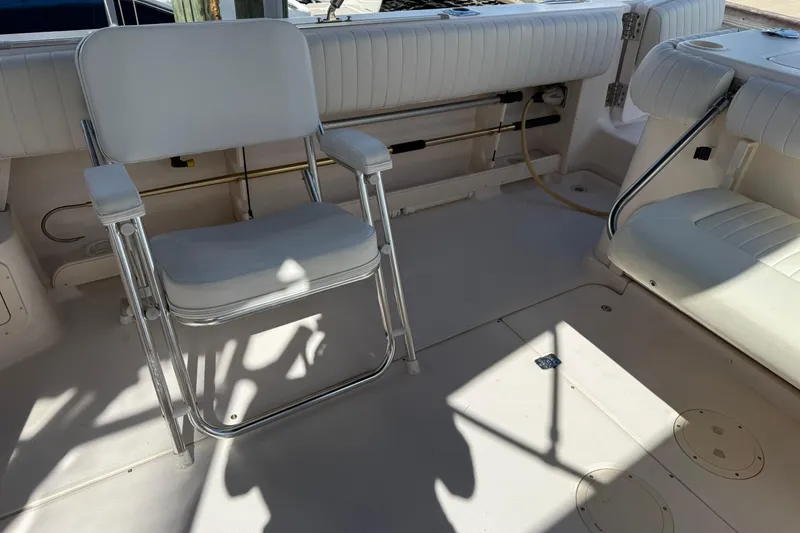 Slide: The Image of 2009 Grady-White Marlin 300 boat interior with white seating and fishing chair. - 31