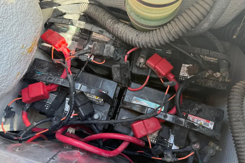 Slide: The Image of Battery compartment of 2009 Grady-White Marlin 300 with red and black cables. - 41