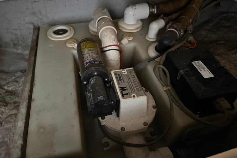 Slide: The Image of 2009 Grady-White Marlin 300 boat plumbing system with pump and pipes. - 42