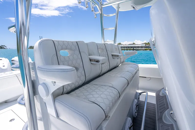 Slide: The Image of Luxurious seating on 2021 Contender 44 CB boat, featuring elegant design and ocean backdrop. - 15