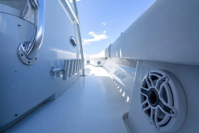 Slide: The Image of 2021 Contender 44 CB boat deck with speaker, stainless steel railing, and clear blue sky. - 26