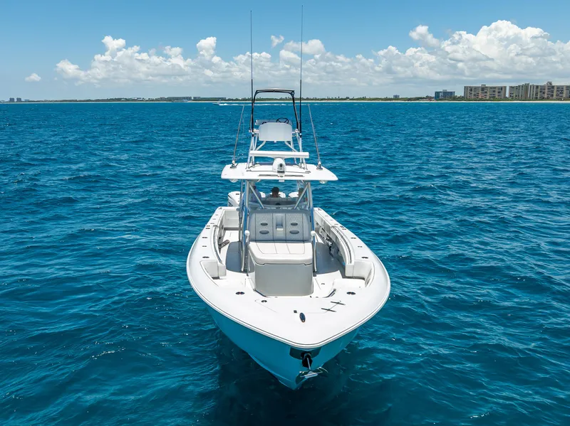 Slide: The Image of 2021 Contender 44 CB boat on clear blue ocean under a sunny sky. - 27