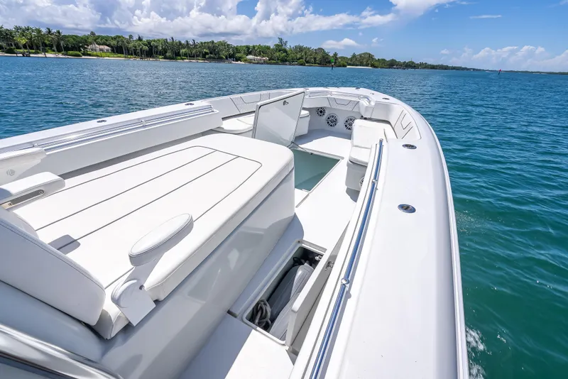 Slide: The Image of 2021 Contender 44 CB boat on clear blue water, featuring spacious seating and sleek design. - 30