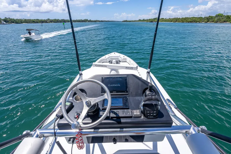 Slide: The Image of 2021 Contender 44 CB boat helm with Garmin navigation, cruising on a sunny day. - 35