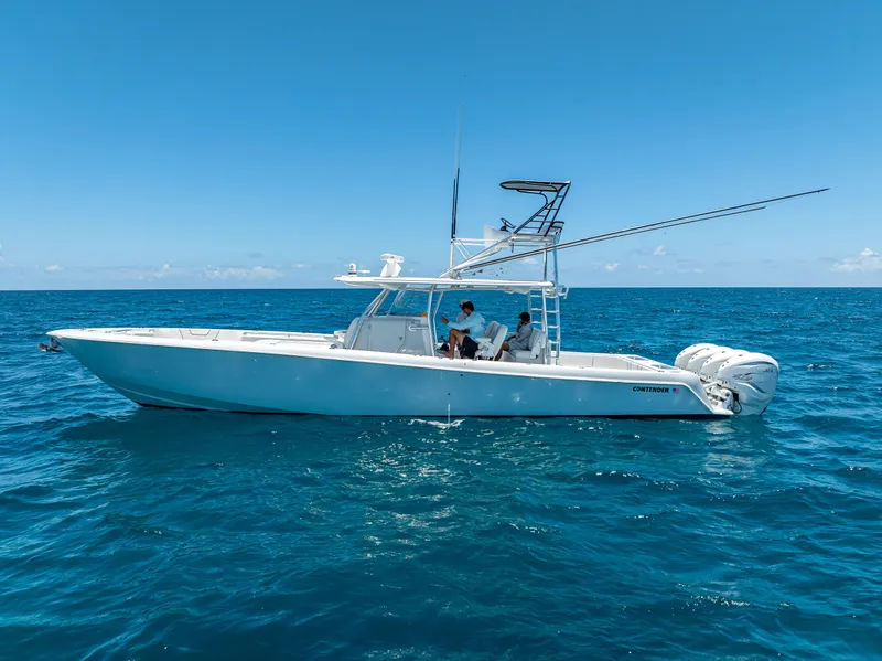 Slide: The Image of 2021 Contender 44 CB boat on open ocean under clear blue sky. - 37