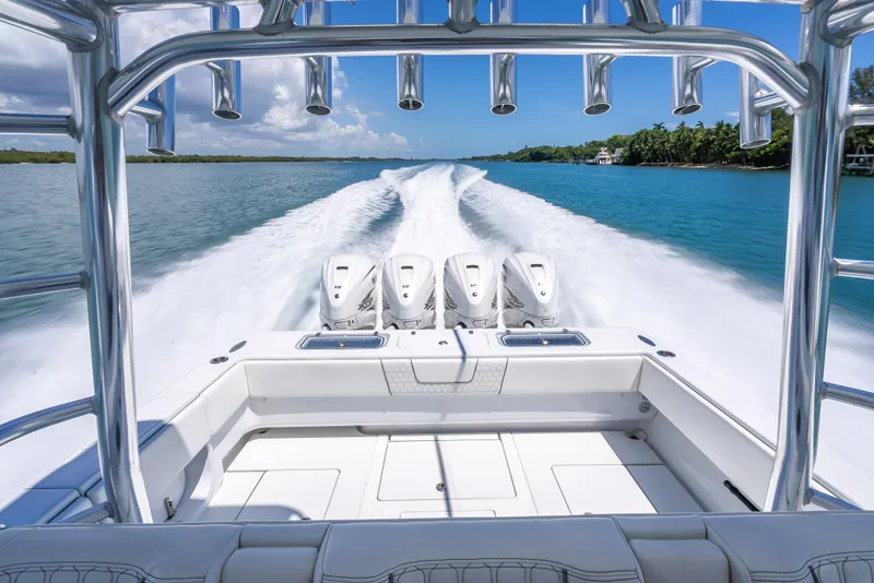 Slide: The Image of Contender 44 CB 2021 boat cruising on clear blue water, showcasing powerful engines. - 39