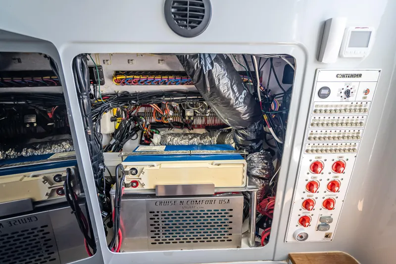 Slide: The Image of Engine compartment of a 2021 Contender 44 CB boat, showcasing wiring and control panel. - 43