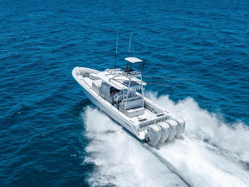 Slide: The Image of 2021 Contender 44 CB boat cruising swiftly on open blue ocean waters. - 47