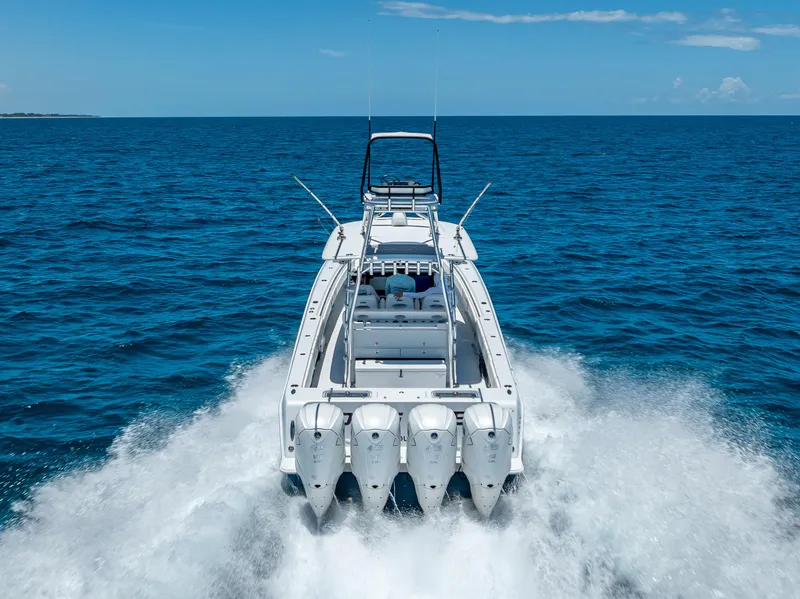 Slide: The Image of Contender 44 CB 2021 boat cruising on open ocean with four powerful engines. - 5