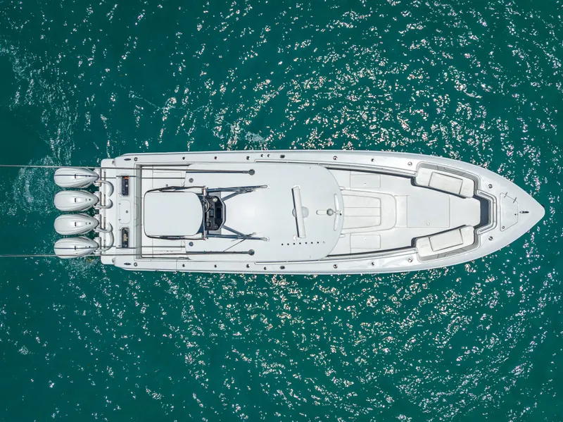 Slide: The Image of Top view of 2021 Contender 44 CB boat on clear blue water. - 7