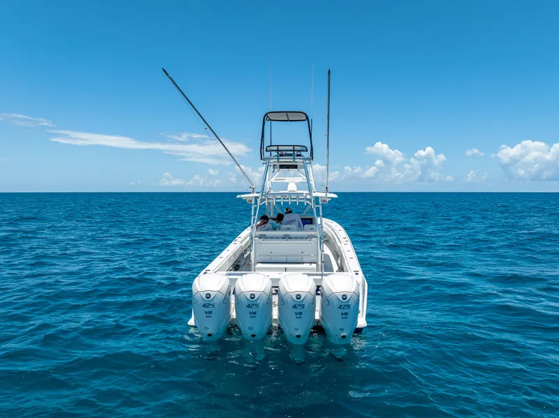 Slide: The Image of 2021 Contender 44 CB boat with four engines on open ocean under clear blue sky. - 9