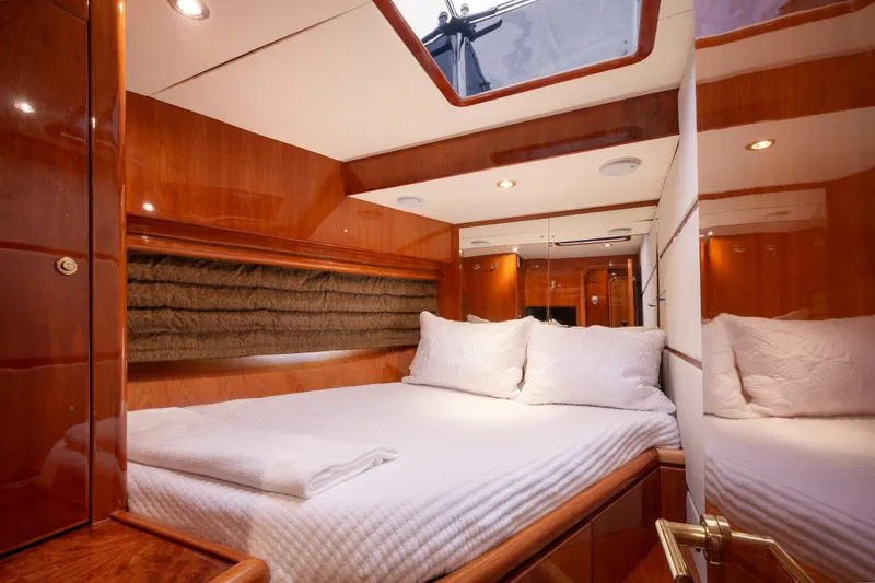 Slide: The Image of Luxurious cabin interior of 2003 Hargrave Skylounge yacht with elegant wood finish and cozy bedding. - 26