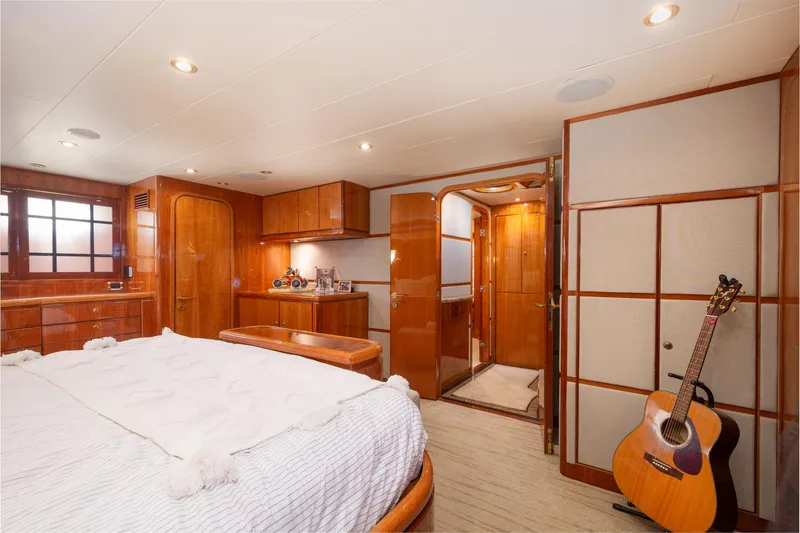 Slide: The Image of Luxurious 2003 Hargrave Skylounge yacht bedroom with wood paneling and acoustic guitar. - 30
