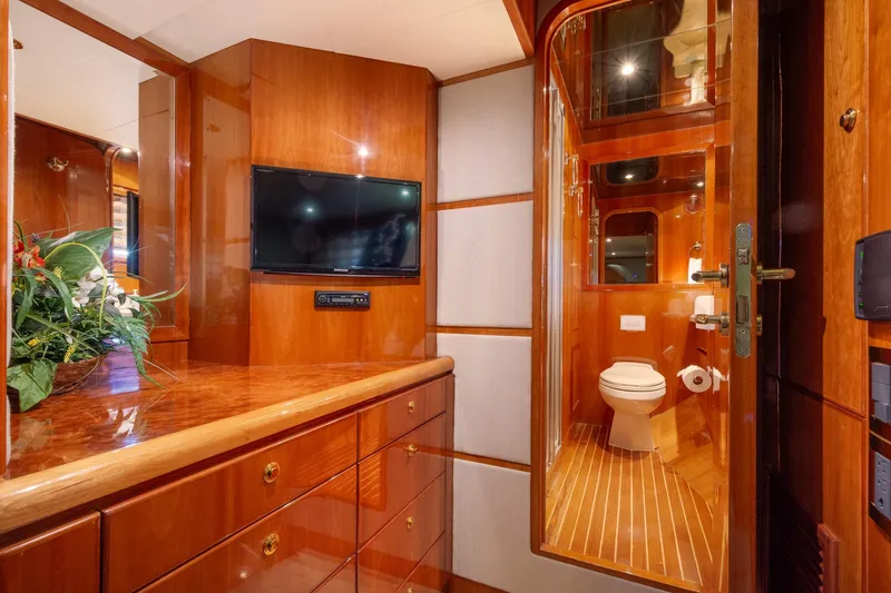Slide: The Image of Luxurious 2003 Hargrave Skylounge yacht interior with wood finish, TV, and bathroom. - 31