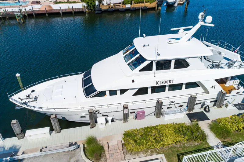 Slide: The Image of 2003 Hargrave Skylounge yacht docked, featuring sleek design and spacious upper deck. - 4