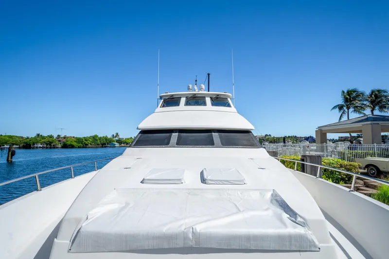 Slide: The Image of 2003 Hargrave Skylounge yacht docked by a scenic waterfront under clear blue skies. - 5