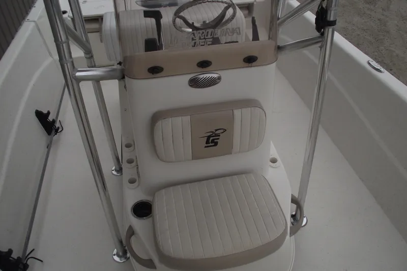 Slide: The Image of 2016 Carolina Skiff 198 DLV boat interior with seating and steering console. - 10