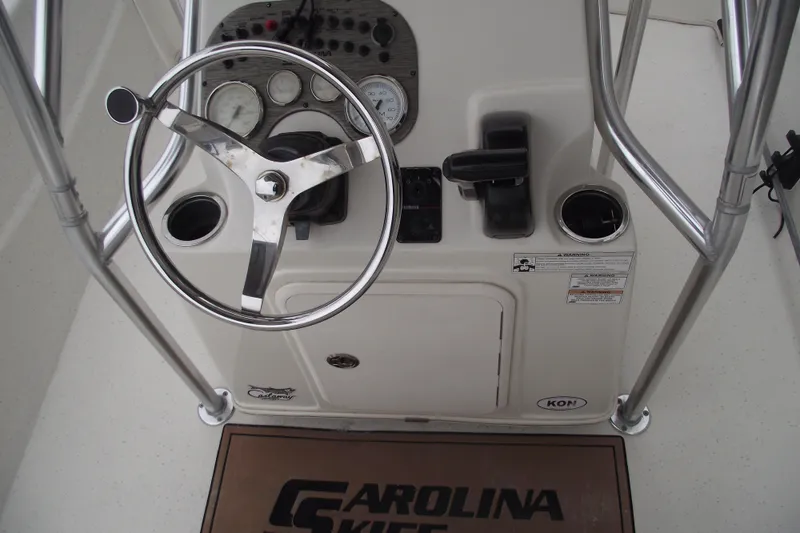 Slide: The Image of 2016 Carolina Skiff 198 DLV boat console with steering wheel and controls. - 16
