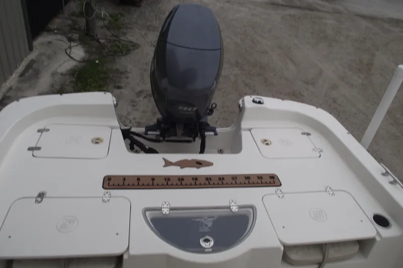 Slide: The Image of 2016 Carolina Skiff 198 DLV boat with outboard motor and fish ruler on deck. - 18