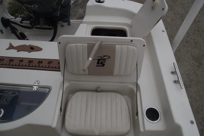 Slide: The Image of 2016 Carolina Skiff 198 DLV boat interior with seating and storage compartments. - 24