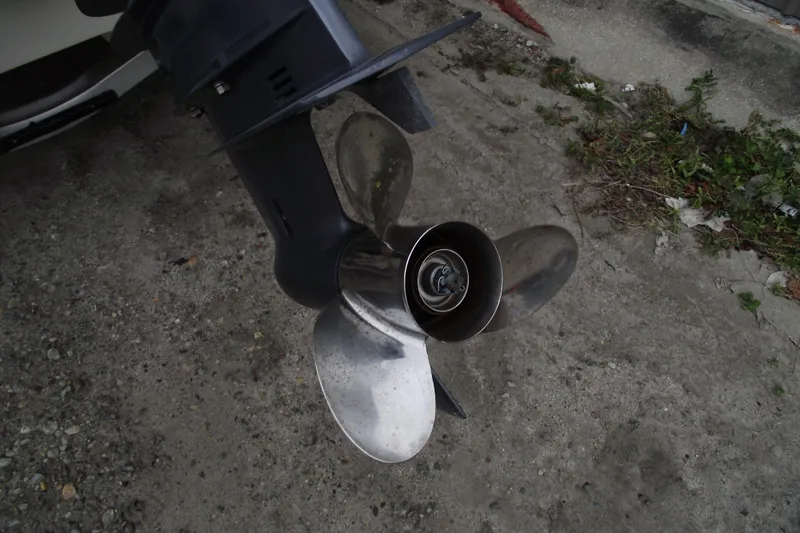 Slide: The Image of Close-up of a 2016 Carolina Skiff 198 DLV boat propeller on gravel. - 4