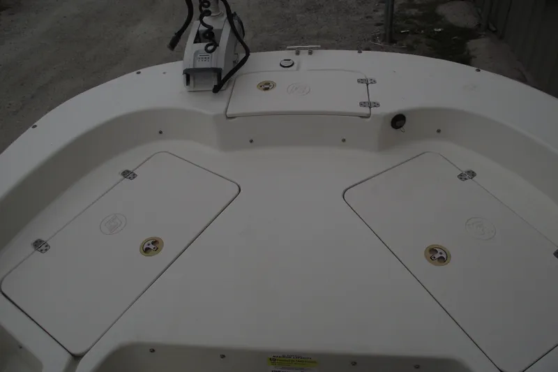 Slide: The Image of 2016 Carolina Skiff 198 DLV boat deck with storage compartments and control panel. - 7