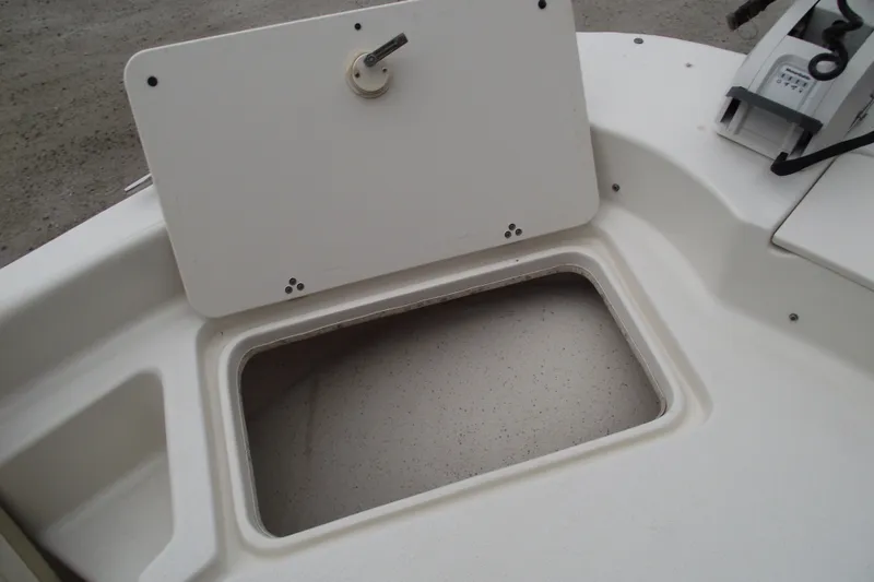 Slide: The Image of 2016 Carolina Skiff 198 DLV boat storage compartment with open hatch. - 8