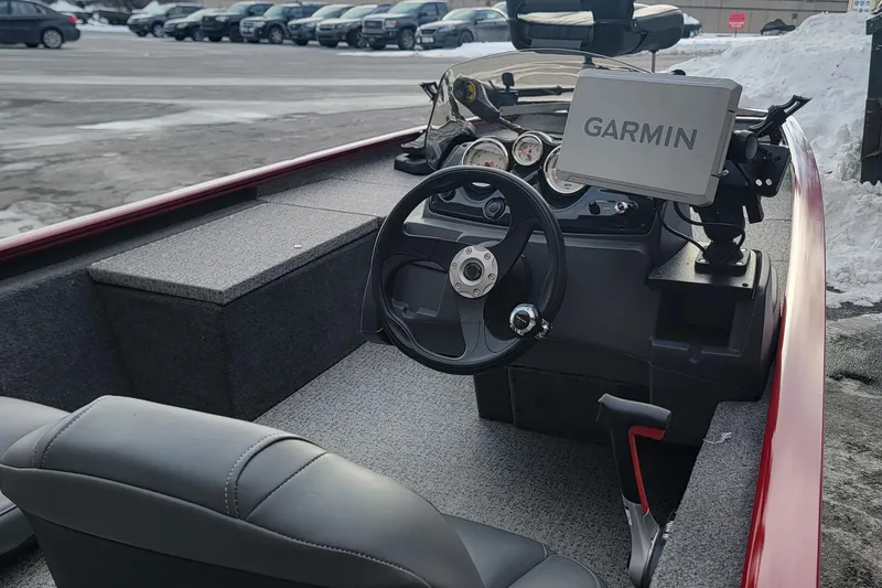 Slide: The Image of 2024 Tracker Pro 170 boat interior with Garmin navigation system, steering wheel, and seating. - 4