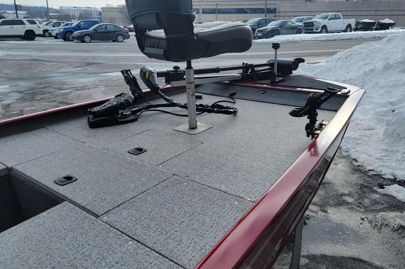 Slide: The Image of 2024 Tracker Pro 170 boat deck with seating and equipment, parked in snowy lot. - 5