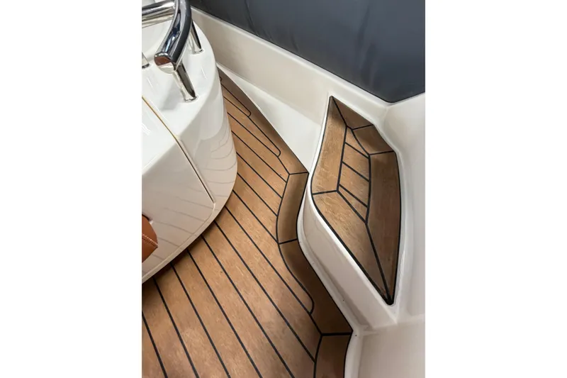 Slide: The Image of 2023 Cobra Ribs Nautique 8.2m boat interior with teak flooring and sleek design. - 13