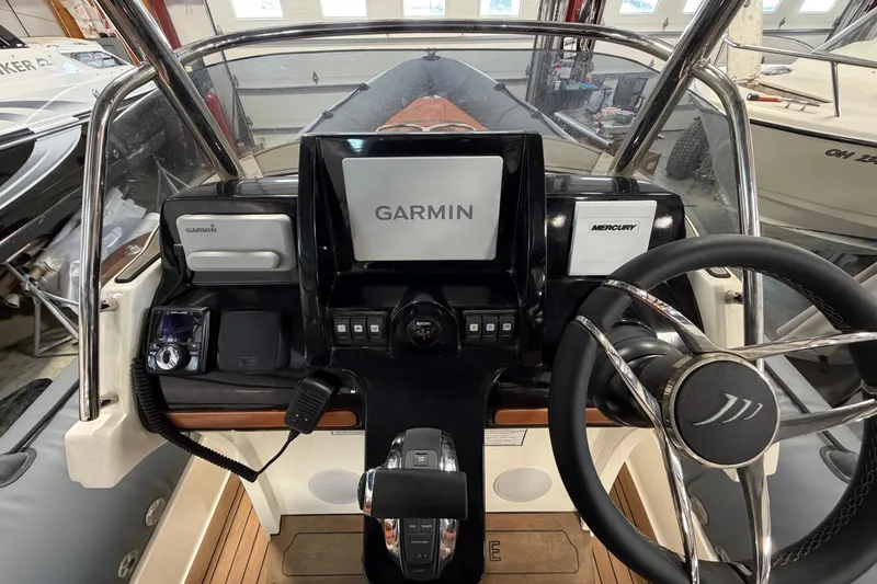 Slide: The Image of 2023 Cobra Ribs Nautique 8.2m dashboard with Garmin and Mercury controls. - 9