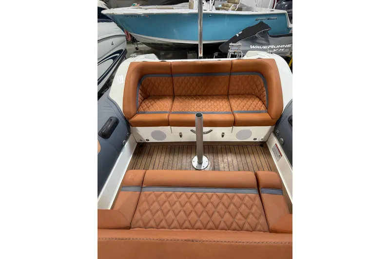Slide: The Image of 2023 Cobra Ribs Nautique 8.2m boat interior with brown quilted seating. - 11