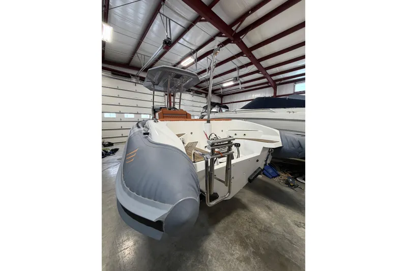Slide: The Image of 2023 Cobra Ribs Nautique 8.2m boat in a garage, showcasing sleek design and modern features. - 16