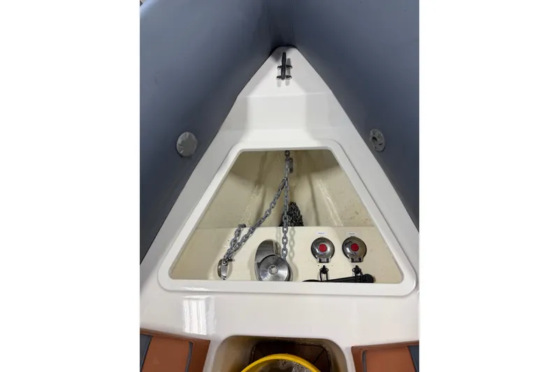 Slide: The Image of 2023 Cobra Ribs Nautique 8.2m anchor compartment with chain and controls. - 4