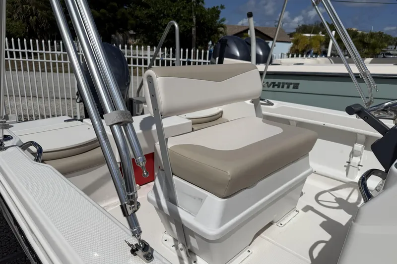 Slide: The Image of 2017 Robalo R160 Center Console boat interior with beige seating and stainless steel fixtures. - 4