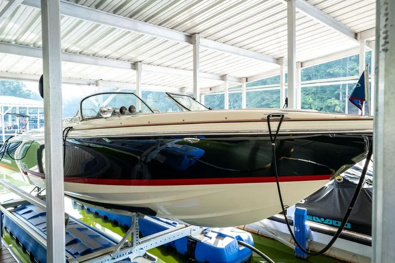 The Image of 2023 Chris-Craft Launch 27 boat docked in a covered marina. - 0