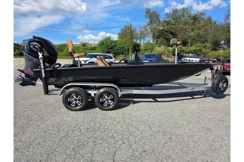 The Image of 2026 Xpress XR21 Bass boat on trailer, parked outdoors under blue sky. - 0