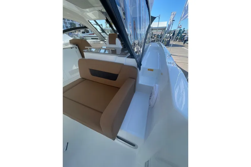 Slide: The Image of 2026 Jeanneau TH38 boat interior with brown seating and sleek design. - 12