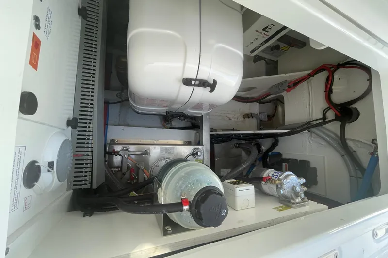 Slide: The Image of Engine compartment of 2026 Jeanneau TH38 boat, showcasing mechanical components and wiring. - 17