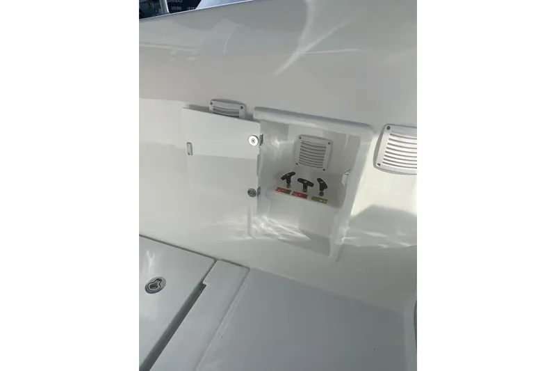 Slide: The Image of Control panel on Jeanneau TH38 boat, 2026 model, with open compartment and switches. - 18