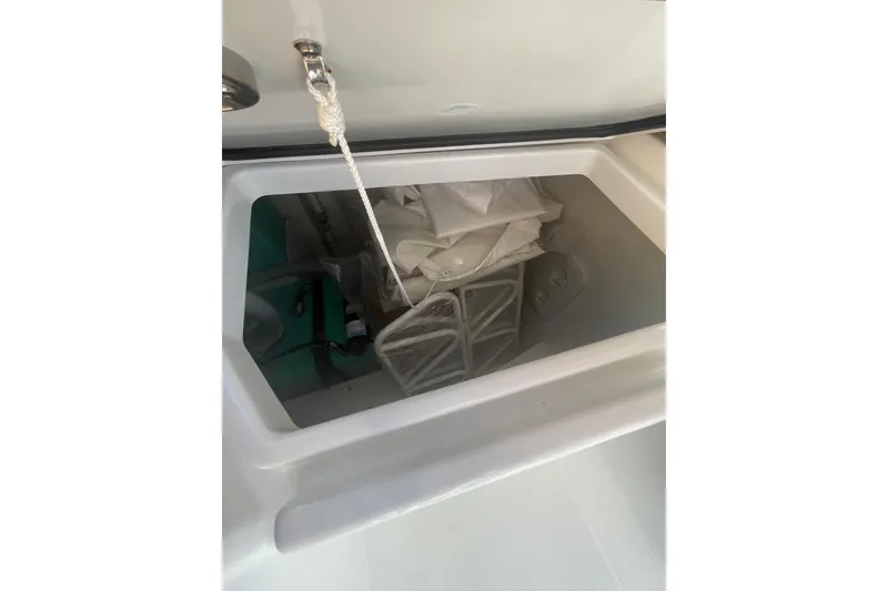 Slide: The Image of Storage compartment on a 2026 Jeanneau TH38 boat, containing equipment and supplies. - 19