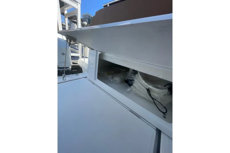 Slide: The Image of Open storage compartment on 2026 Jeanneau TH38 boat, showing ropes and equipment. - 21